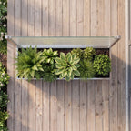 Ansicht von oben auf den Sichtschutz-Pflanzkasten aus Edelstahl mit seitlicher Glaswand und bepflanztem Pflanzkasten auf einer modernen Terrasse